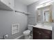 Bathroom with light blue walls, toilet, sink, mirror and storage at 700 Market St # 214, Chapel Hill, NC 27516