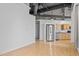 Open concept kitchen with stainless steel appliances and light wood cabinets, adjacent to a spacious living area at 700 Market St # 214, Chapel Hill, NC 27516