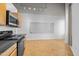 Modern kitchen with black appliances and light wood cabinets at 700 Market St # 214, Chapel Hill, NC 27516