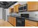 Kitchen with wood cabinets and stainless steel microwave at 700 Market St # 214, Chapel Hill, NC 27516