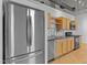 Modern kitchen features stainless steel appliances and light wood cabinets with an industrial design at 700 Market St # 214, Chapel Hill, NC 27516