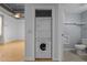 Efficient laundry setup with stacked washer and dryer, conveniently located near a pristine, well-lit bathroom at 700 Market St # 214, Chapel Hill, NC 27516