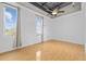A bright living room space with hardwood floors, exposed ceiling and large windows with curtains at 700 Market St # 214, Chapel Hill, NC 27516