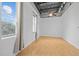 A bright living room space with hardwood floors, exposed ceiling and large windows with curtains at 700 Market St # 214, Chapel Hill, NC 27516