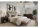 Comfortable main bedroom with stylish decor, including lamps, modern art, and dresser at 700 Market St # 214, Chapel Hill, NC 27516