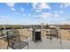Outdoor rooftop space with a grill and chairs for a relaxing and enjoyable entertainment area at 700 Market St # 214, Chapel Hill, NC 27516
