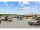 Inviting rooftop patio with lounge chairs and dining area under a sunny sky at 700 Market St # 214, Chapel Hill, NC 27516