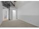 Open-concept room with neutral carpet and white walls, featuring a walk-in closet and an ensuite bathroom at 700 Market St # 214, Chapel Hill, NC 27516