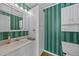 Bathroom with vertical striped wall paper, a mirrored vanity, and storage at 706 Forest Dr, Garner, NC 27529