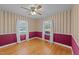 Bright bedroom featuring hardwood floors, neutral wallpaper, and white-trimmed windows offering plenty of natural light at 706 Forest Dr, Garner, NC 27529