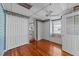 Cozy bedroom features a ceiling fan, natural lighting, and original hardwood floors at 706 Forest Dr, Garner, NC 27529