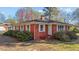 Charming brick home featuring a well-maintained lawn, manicured shrubbery, and a classic design at 706 Forest Dr, Garner, NC 27529
