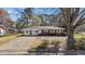 Charming brick and white home with a well-maintained lawn and paved driveway at 706 Forest Dr, Garner, NC 27529