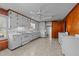 Bright kitchen with wooden paneling, white cabinetry, and modern appliances at 706 Forest Dr, Garner, NC 27529