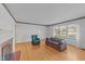 Comfortable living room features hardwood floors, fireplace, large windows, and a decorative border around the ceiling at 706 Forest Dr, Garner, NC 27529