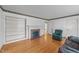 Spacious living room featuring hardwood floors, a fireplace, built-in shelves, and comfortable seating at 706 Forest Dr, Garner, NC 27529