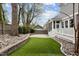 Home's backyard boasts a manicured lawn, stone patio, and well-maintained landscaping at 711 Virginia Ave, Raleigh, NC 27604