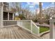 Wooden deck leads to a lush backyard featuring artificial turf and a stone border at 711 Virginia Ave, Raleigh, NC 27604