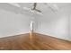 The spacious bedroom features hardwood floors and a coffered ceiling with a modern ceiling fan at 711 Virginia Ave, Raleigh, NC 27604