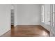 Bedroom featuring hardwood floors, white walls, natural light, and an open closet at 711 Virginia Ave, Raleigh, NC 27604