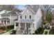 Charming two-story home featuring gray siding, white trim, a metal roof, and a covered front porch at 711 Virginia Ave, Raleigh, NC 27604