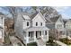 Two-story home with gray siding, white trim, covered front porch, and well-maintained landscaping at 711 Virginia Ave, Raleigh, NC 27604