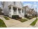 Two-story home with a welcoming front porch, white columns, and well-manicured landscaping leading to the entrance at 711 Virginia Ave, Raleigh, NC 27604