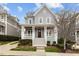 Charming two-story home featuring a covered front porch with white columns and manicured landscaping at 711 Virginia Ave, Raleigh, NC 27604