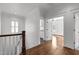 Hallway view showing stairs, hardwood floors, and multiple room access at 711 Virginia Ave, Raleigh, NC 27604