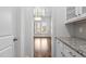 Hallway view toward a sunroom with abundant natural light and hardwood floors at 711 Virginia Ave, Raleigh, NC 27604