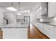 Gourmet kitchen with granite countertops, modern appliances, and hardwood floors at 711 Virginia Ave, Raleigh, NC 27604