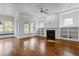 Open-concept living area with hardwood floors, a fireplace, and built-in shelving at 711 Virginia Ave, Raleigh, NC 27604