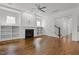 Open-concept living area with hardwood floors, a fireplace, and built-in shelving at 711 Virginia Ave, Raleigh, NC 27604