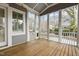 Relaxing screened porch with wood flooring, ceiling, and views of the lush backyard at 711 Virginia Ave, Raleigh, NC 27604