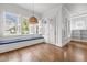 Bright sunroom with built-in bench and large windows overlooking the yard at 711 Virginia Ave, Raleigh, NC 27604