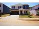 New two-story home featuring an attached two car garage, manicured lawn and neutral color palette at 721 Deschutes Dr, Garner, NC 27529
