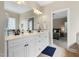 Bathroom vanity area with white cabinets and access to main bedroom at 7252 Bedford Ridge Dr, Apex, NC 27539