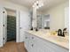 Bright bathroom with double sinks, updated fixtures, and tile flooring at 7252 Bedford Ridge Dr, Apex, NC 27539