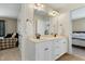 Bathroom with double sink vanity, tile floors, and doorways leading to adjacent rooms at 7252 Bedford Ridge Dr, Apex, NC 27539