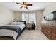 A comfortable bedroom with carpet, natural light, ceiling fan, and neutral walls at 7252 Bedford Ridge Dr, Apex, NC 27539