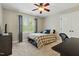Comfortable bedroom features a ceiling fan, a well-lit window and a small bed at 7252 Bedford Ridge Dr, Apex, NC 27539