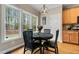 Charming dining area with a black table, a window with a view, and a stylish pendant light at 7252 Bedford Ridge Dr, Apex, NC 27539