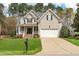 Beautiful exterior view of a two-story home featuring a well-kept lawn and a spacious driveway leading to the garage at 7252 Bedford Ridge Dr, Apex, NC 27539