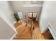 Open foyer featuring hardwood floors, a staircase, and a view of the front entrance through glass-paneled doors at 7252 Bedford Ridge Dr, Apex, NC 27539