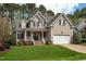 Charming two-story home with a well-manicured lawn, inviting front porch, and an attached two-car garage at 7252 Bedford Ridge Dr, Apex, NC 27539