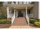 Welcoming front porch with brick steps, white railings, and a charming entrance door with sidelights at 7252 Bedford Ridge Dr, Apex, NC 27539