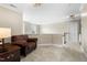 A cozy hallway features a leather armchair, neutral carpet, and natural lighting at 7252 Bedford Ridge Dr, Apex, NC 27539