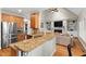 Kitchen featuring granite countertops, stainless appliances, and an open layout to the living room at 7252 Bedford Ridge Dr, Apex, NC 27539