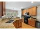 Well-equipped kitchen featuring granite countertops, stainless steel sink, and a view to the dining area at 7252 Bedford Ridge Dr, Apex, NC 27539