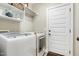 Functional laundry room featuring modern appliances and convenient storage solutions at 7252 Bedford Ridge Dr, Apex, NC 27539